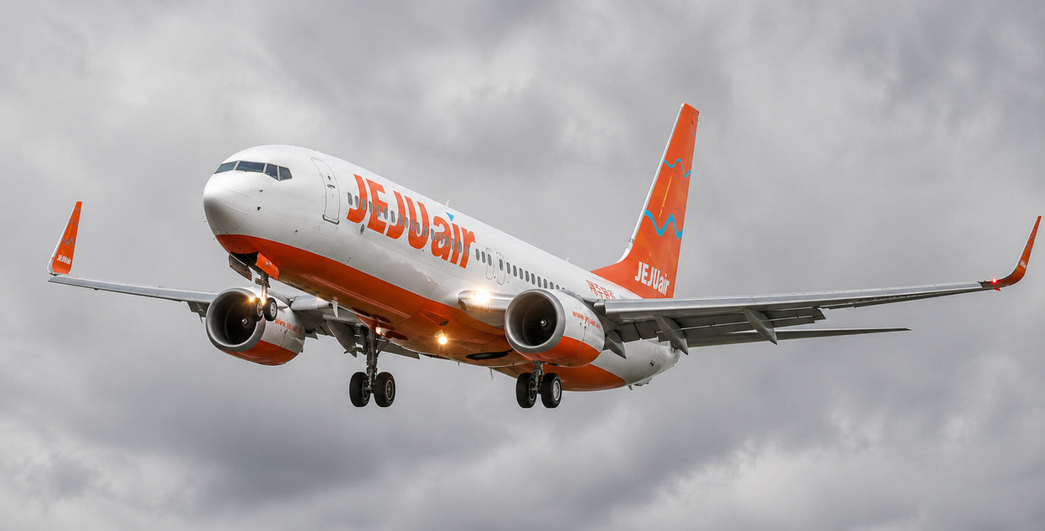 Jeju Air airplane flying against a cloudy sky